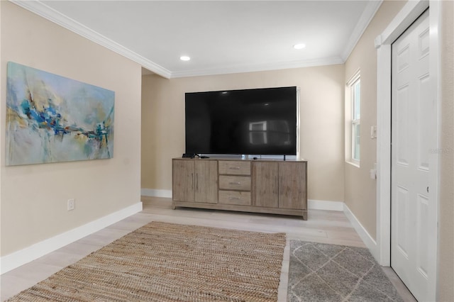 unfurnished living room featuring ornamental molding and light hardwood / wood-style flooring