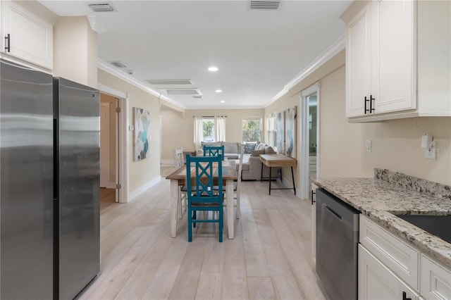 kitchen featuring light hardwood / wood-style flooring, stainless steel appliances, light stone counters, and white cabinets