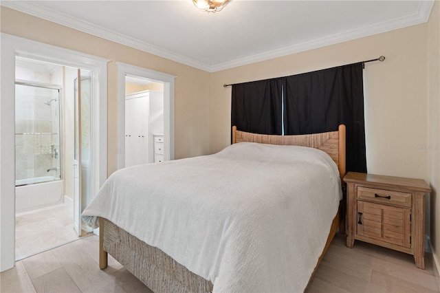 bedroom featuring crown molding, connected bathroom, and light hardwood / wood-style floors