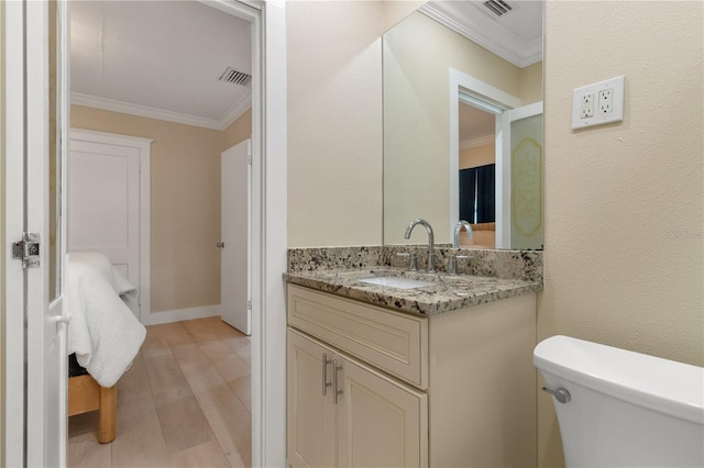 bathroom with crown molding, vanity, toilet, and hardwood / wood-style flooring