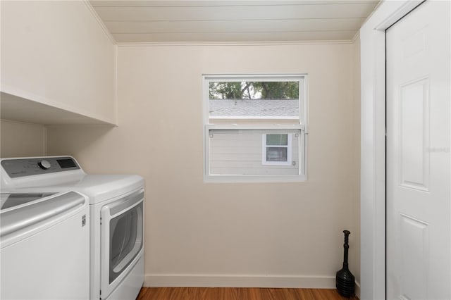 clothes washing area featuring crown molding, independent washer and dryer, and light hardwood / wood-style floors