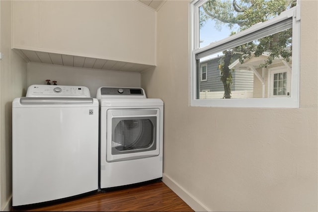 washroom featuring dark wood-type flooring and washer and dryer