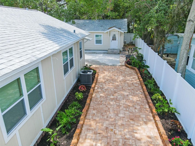 exterior space with central AC unit and a patio