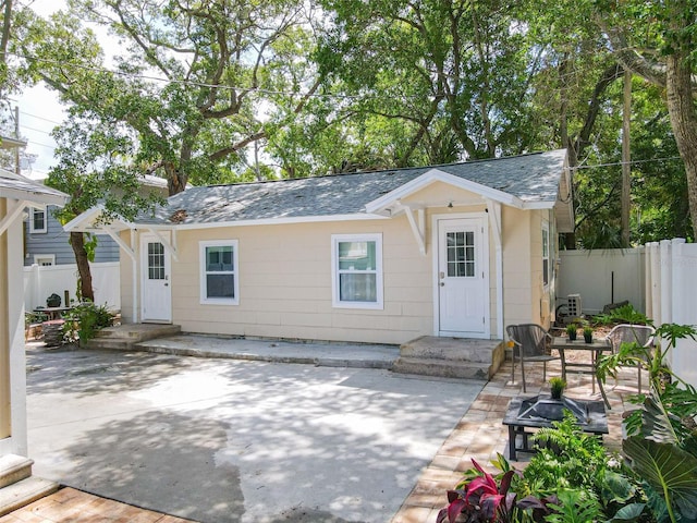 rear view of property with cooling unit and a patio area