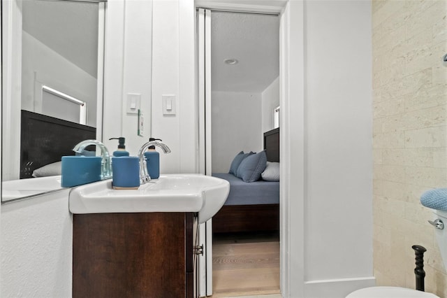 bathroom with vanity and hardwood / wood-style flooring