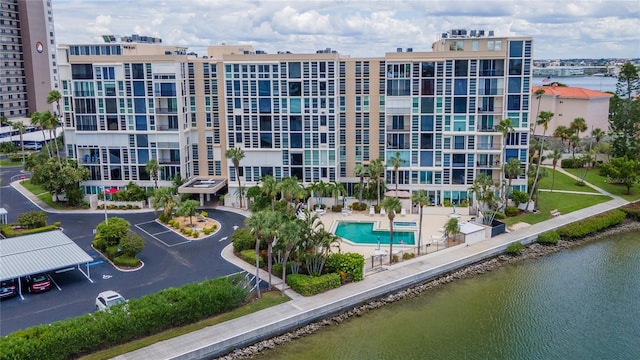 view of property featuring a community pool and a water view