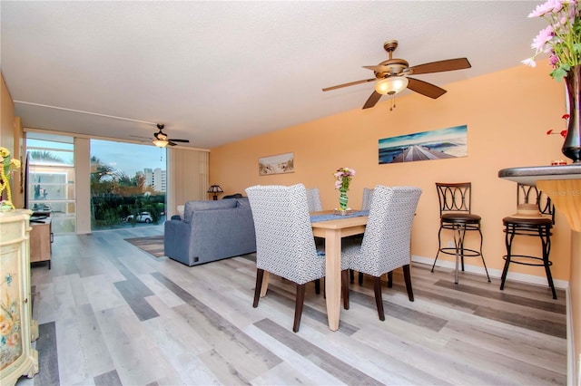 dining area featuring ceiling fan and light hardwood / wood-style flooring