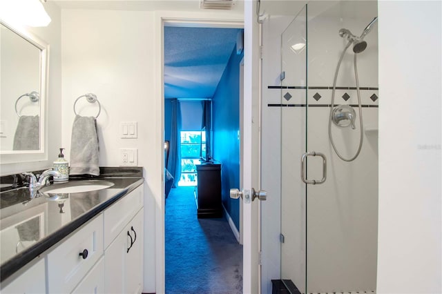 bathroom featuring vanity and an enclosed shower