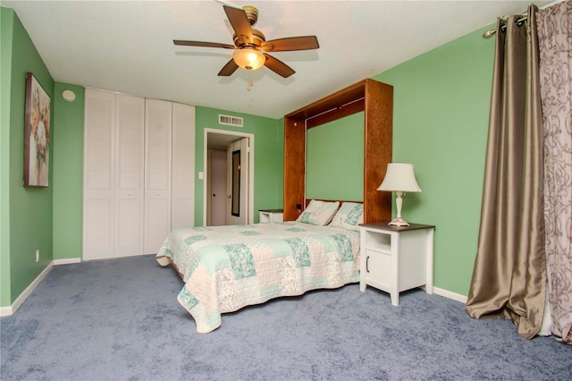 carpeted bedroom with ceiling fan and a closet