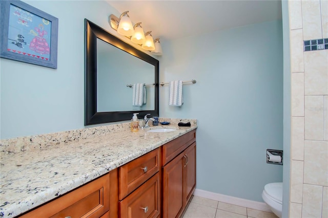 bathroom with vanity, toilet, and tile patterned floors