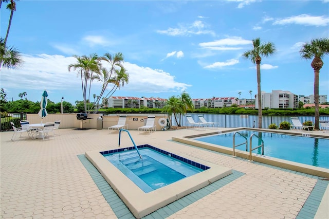 view of swimming pool with a community hot tub and a patio