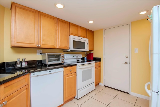 kitchen with white appliances and light tile patterned flooring