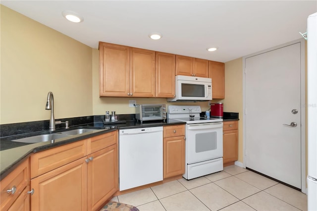 kitchen featuring sink, light tile patterned floors, and white appliances