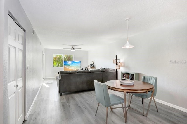 dining room featuring ceiling fan and light wood-type flooring