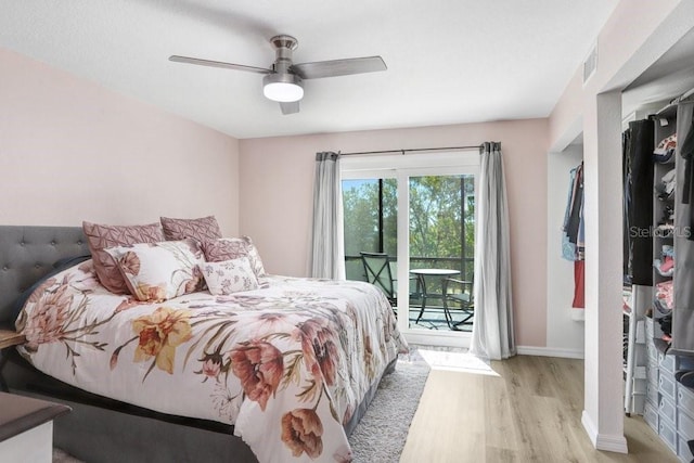 bedroom featuring access to exterior, light hardwood / wood-style floors, and ceiling fan