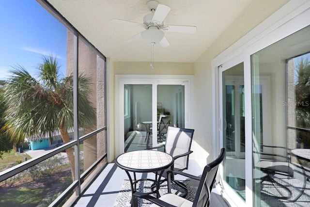 sunroom / solarium featuring ceiling fan