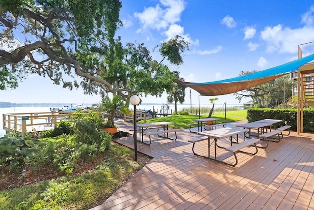 view of property's community with a deck with water view