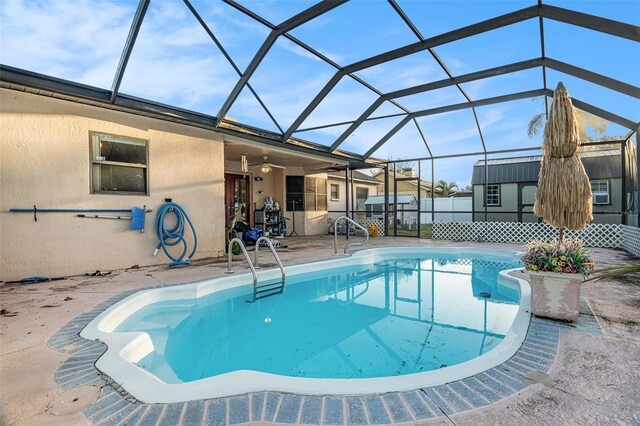 view of swimming pool featuring a patio area, a lanai, and ceiling fan