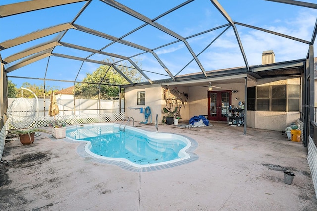 view of pool featuring french doors, ceiling fan, a lanai, and a patio