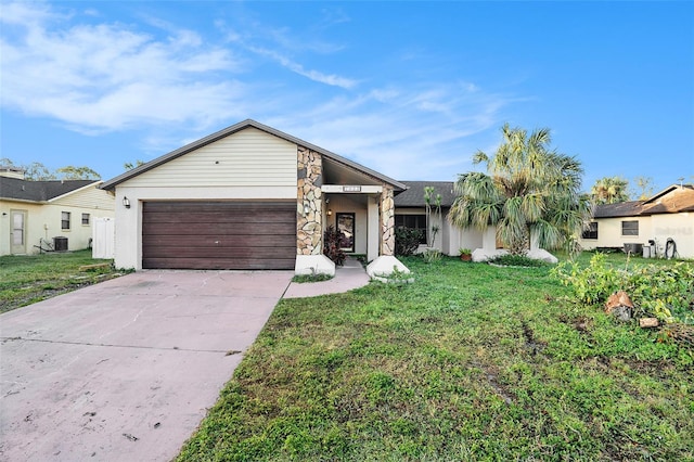 single story home with a garage and a front lawn