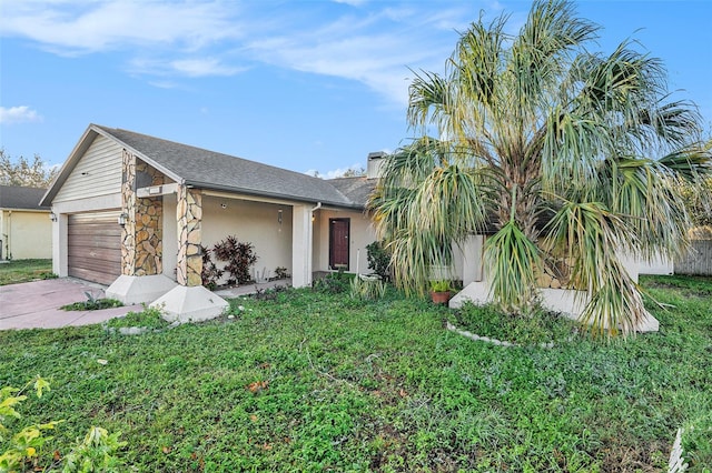 ranch-style home with a front yard and a garage