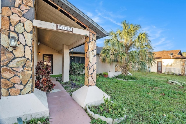 entrance to property with a yard