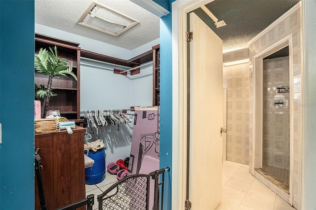 bathroom with tile patterned floors and a textured ceiling