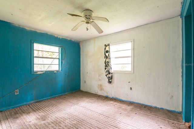 unfurnished room featuring ceiling fan and a healthy amount of sunlight