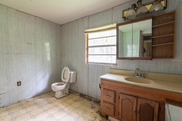 bathroom featuring tile walls, tile patterned flooring, toilet, and vanity