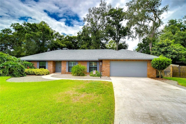 single story home featuring a garage and a front yard