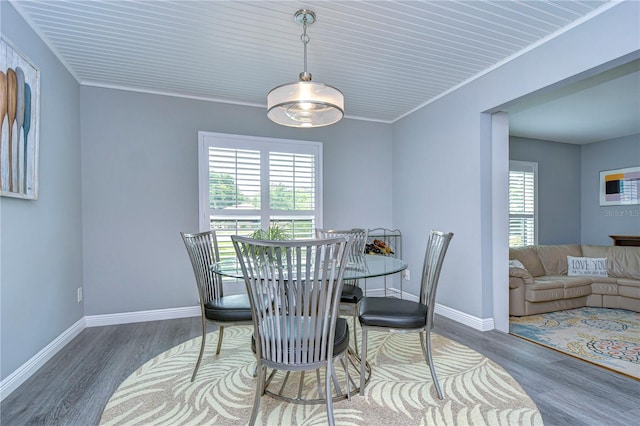 dining room featuring crown molding and dark wood-type flooring