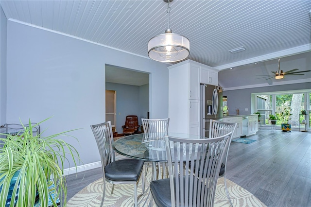 dining area featuring crown molding, hardwood / wood-style flooring, ceiling fan, and wooden ceiling