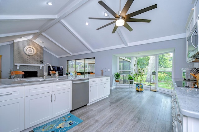 kitchen featuring light wood-type flooring, stainless steel appliances, sink, ceiling fan, and white cabinets