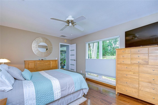 bedroom with ceiling fan and hardwood / wood-style flooring