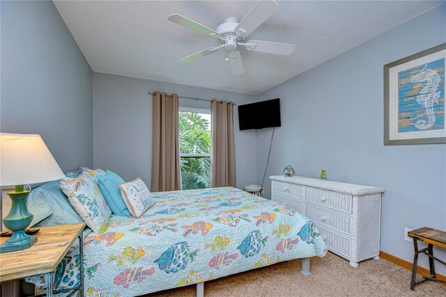 bedroom with light carpet, a textured ceiling, and ceiling fan