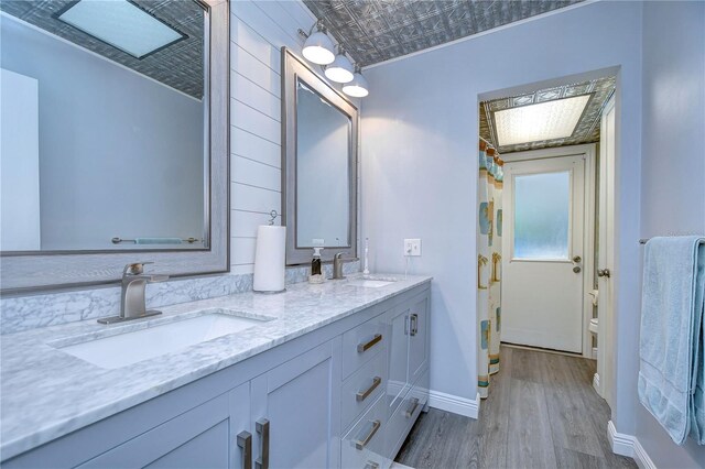 bathroom featuring vanity, toilet, and hardwood / wood-style flooring