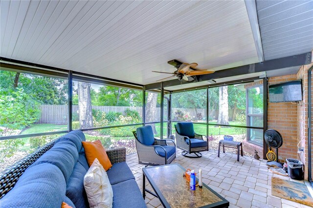 sunroom / solarium featuring plenty of natural light and ceiling fan