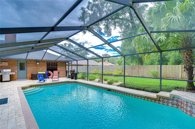 view of pool featuring a patio area, a yard, area for grilling, and a lanai