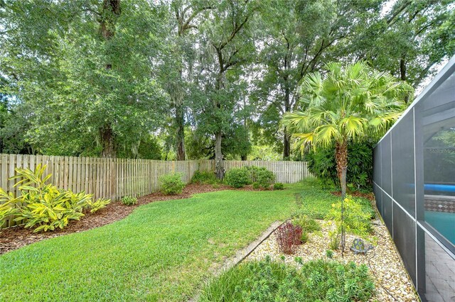 view of yard featuring glass enclosure