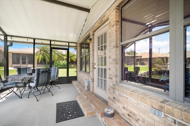 sunroom featuring vaulted ceiling