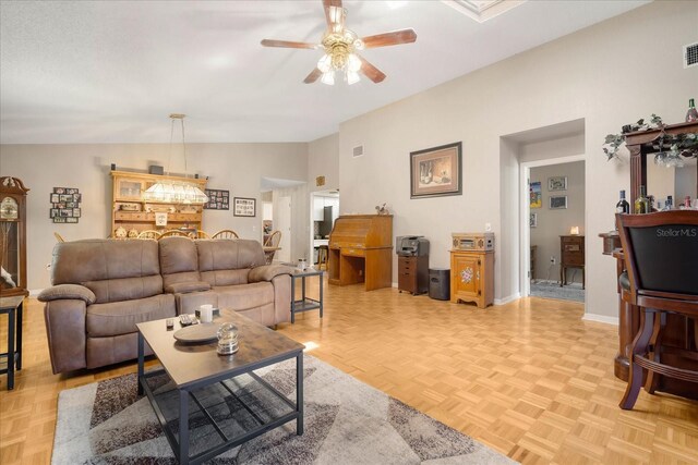 living room featuring ceiling fan, lofted ceiling, and light parquet floors