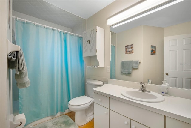 bathroom featuring walk in shower, wood-type flooring, vanity, and toilet