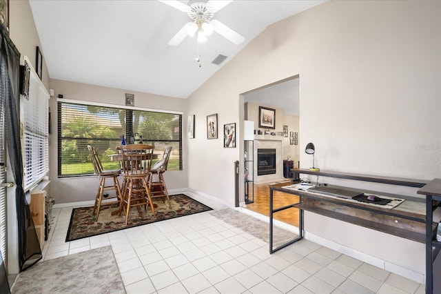 kitchen with ceiling fan, light tile patterned flooring, and vaulted ceiling