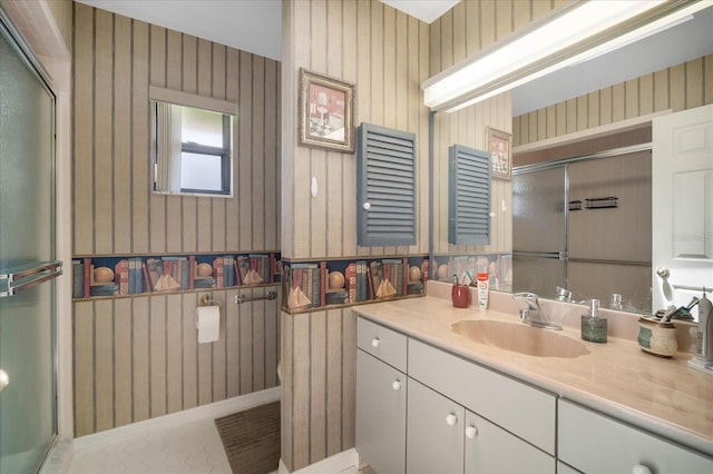 bathroom featuring tile patterned flooring, walk in shower, vanity, and toilet