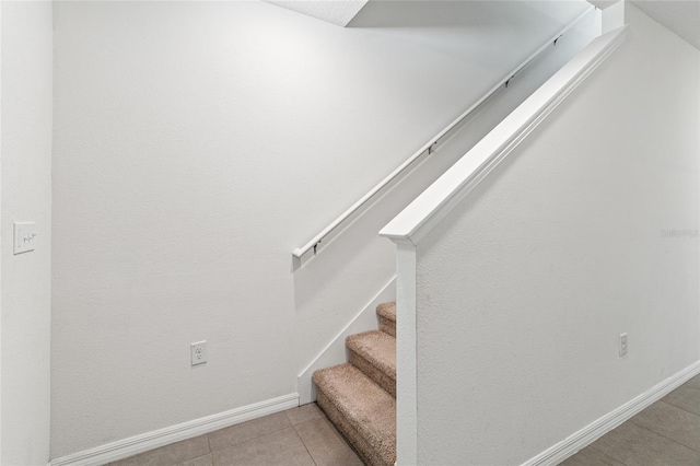 staircase with tile patterned floors