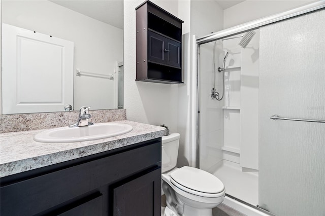 bathroom featuring walk in shower, vanity, and toilet