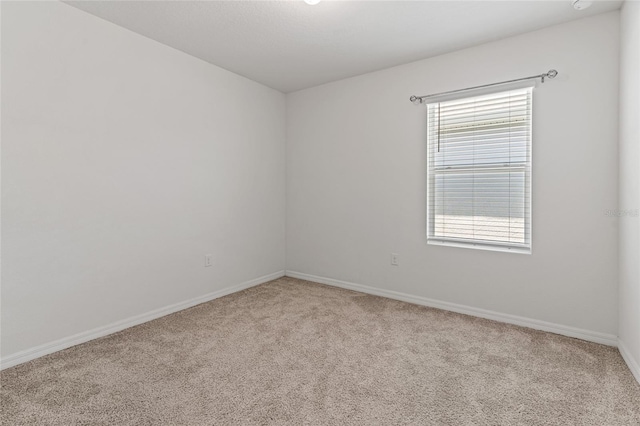 empty room with light carpet and plenty of natural light