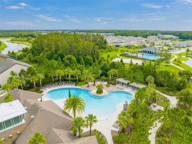 view of swimming pool with a patio and a water view