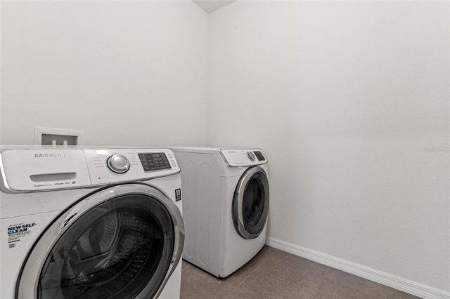 clothes washing area featuring independent washer and dryer and light tile patterned floors