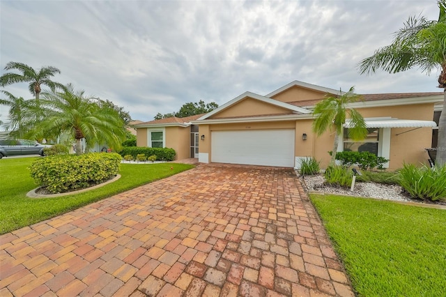 ranch-style house with a garage and a front lawn